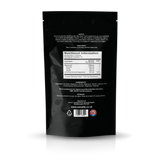 The back of a black stand-up pouch package, showing printed text, a nutrition facts label, ingredients, storage instructions, and a barcode on a white studio background.