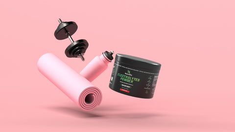 A pink exercise mat and a black tub of Nutrality Electrolyte Powder floating against a solid pink background, with a black dumbbell also floating above.