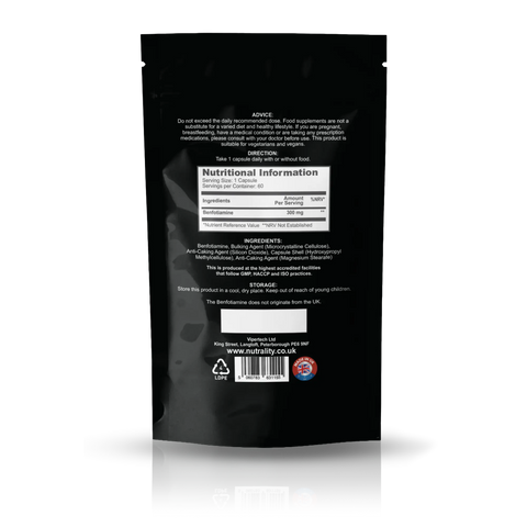 Back view of a black stand-up pouch package, showing nutritional information, ingredients, and a barcode on a white background with a soft reflection.