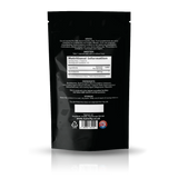 Back view of a black stand-up pouch package, showing nutritional information, ingredients, and a barcode on a white background with a soft reflection.