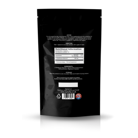 The back of a black resealable stand-up pouch with white text, a nutrition facts label, barcode, and small certification logos, photographed on a light gray background with a reflection below.